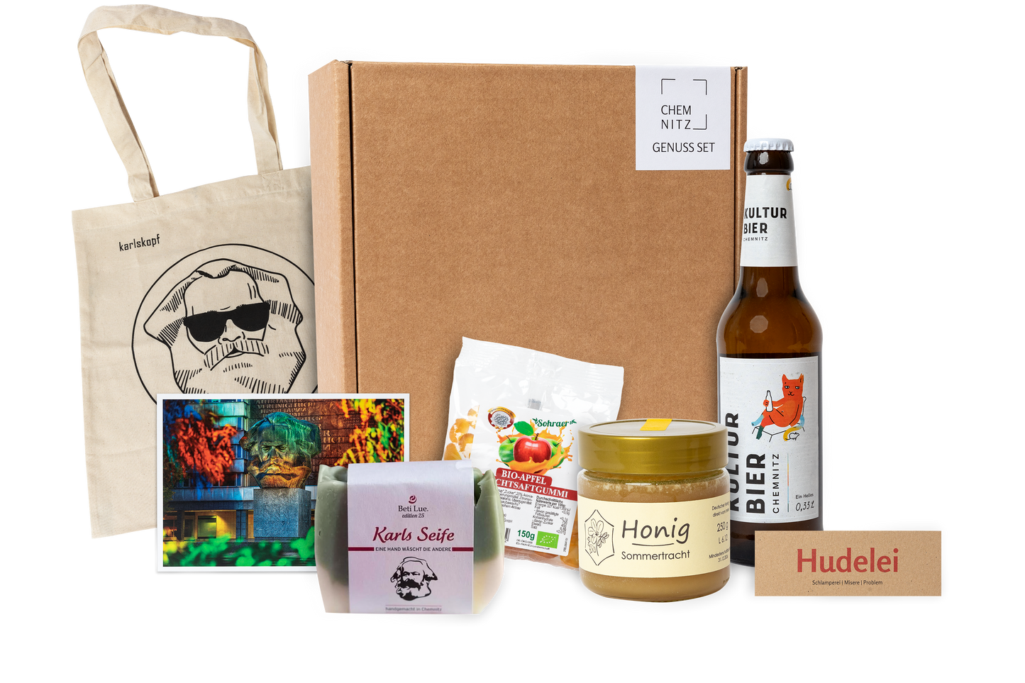 Genuss Set Chemnitz Basis mit Baumwolltasche mit Karlskopf-Logo, Karls Seife, Bio-Fruchtsaftgummi, Honig, Kulturbier Flasche in braunem Karton.