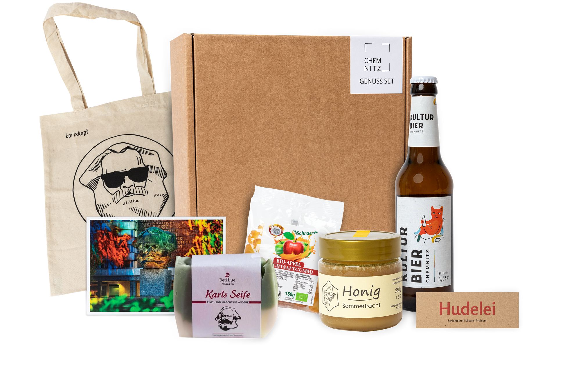 Genuss Set Chemnitz Basis mit Baumwolltasche mit Karlskopf-Logo, Karls Seife, Bio-Fruchtsaftgummi, Honig, Kulturbier Flasche in braunem Karton.