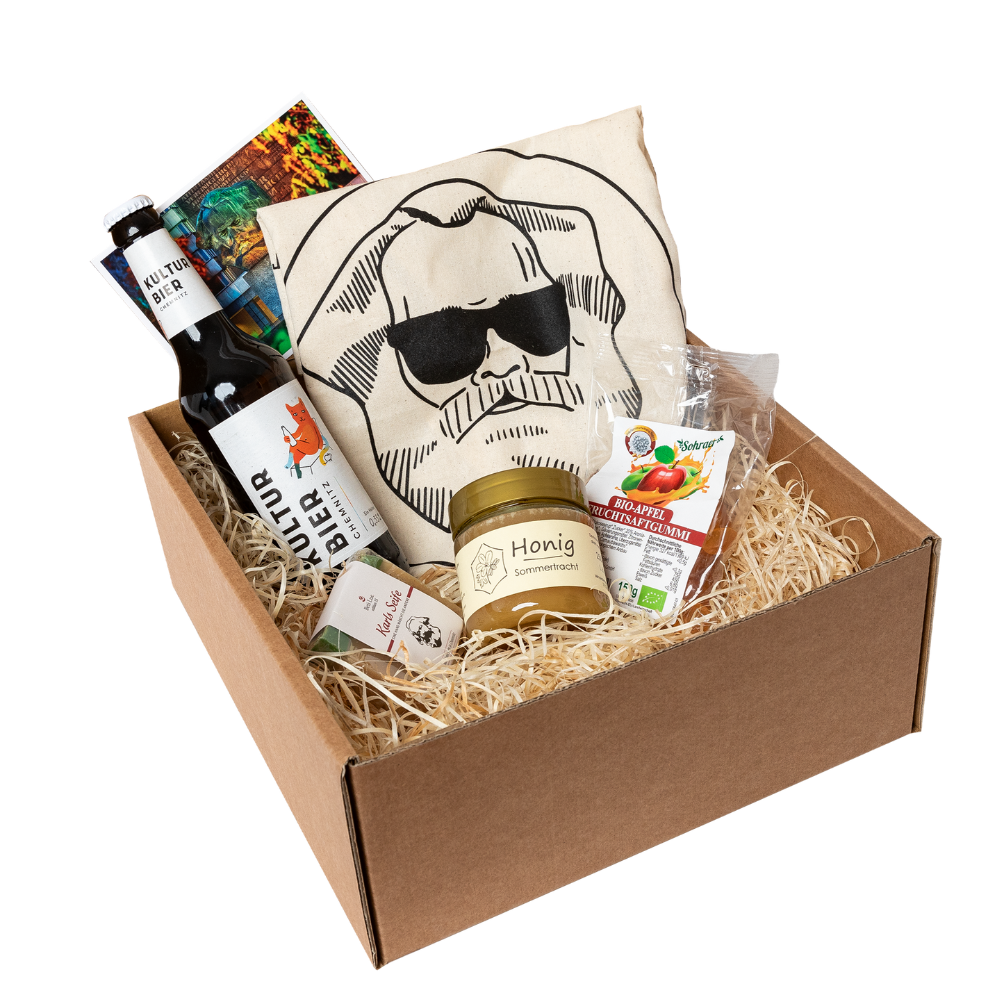 Genuss Set Chemnitz Basis mit Baumwolltasche mit Karlskopf-Logo, Karls Seife, Bio-Fruchtsaftgummi, Honig, Kulturbier Flasche in braunem Karton.