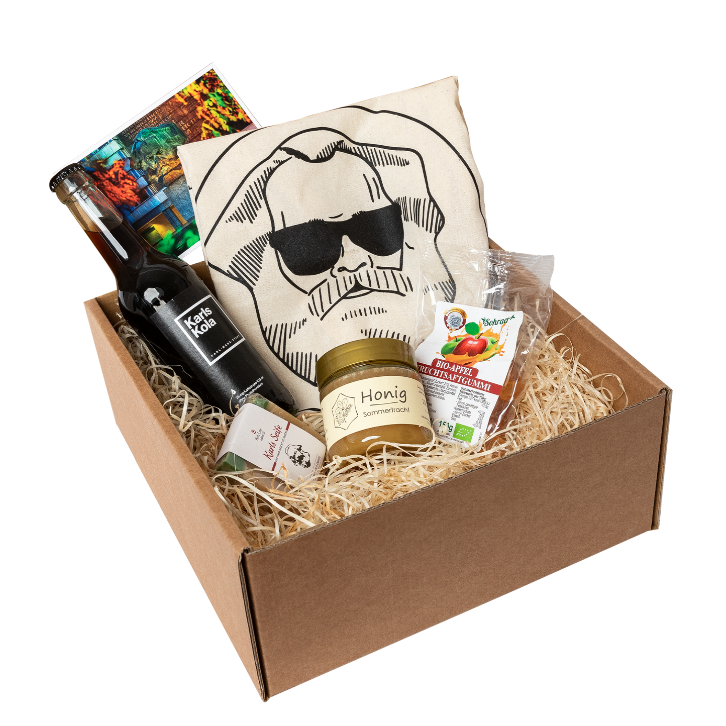 Genuss Set Chemnitz Basis mit Baumwolltasche mit Karlskopf-Logo, Karls Seife, Bio-Fruchtsaftgummi, Honig, Karls Kola Flasche in braunem Karton.