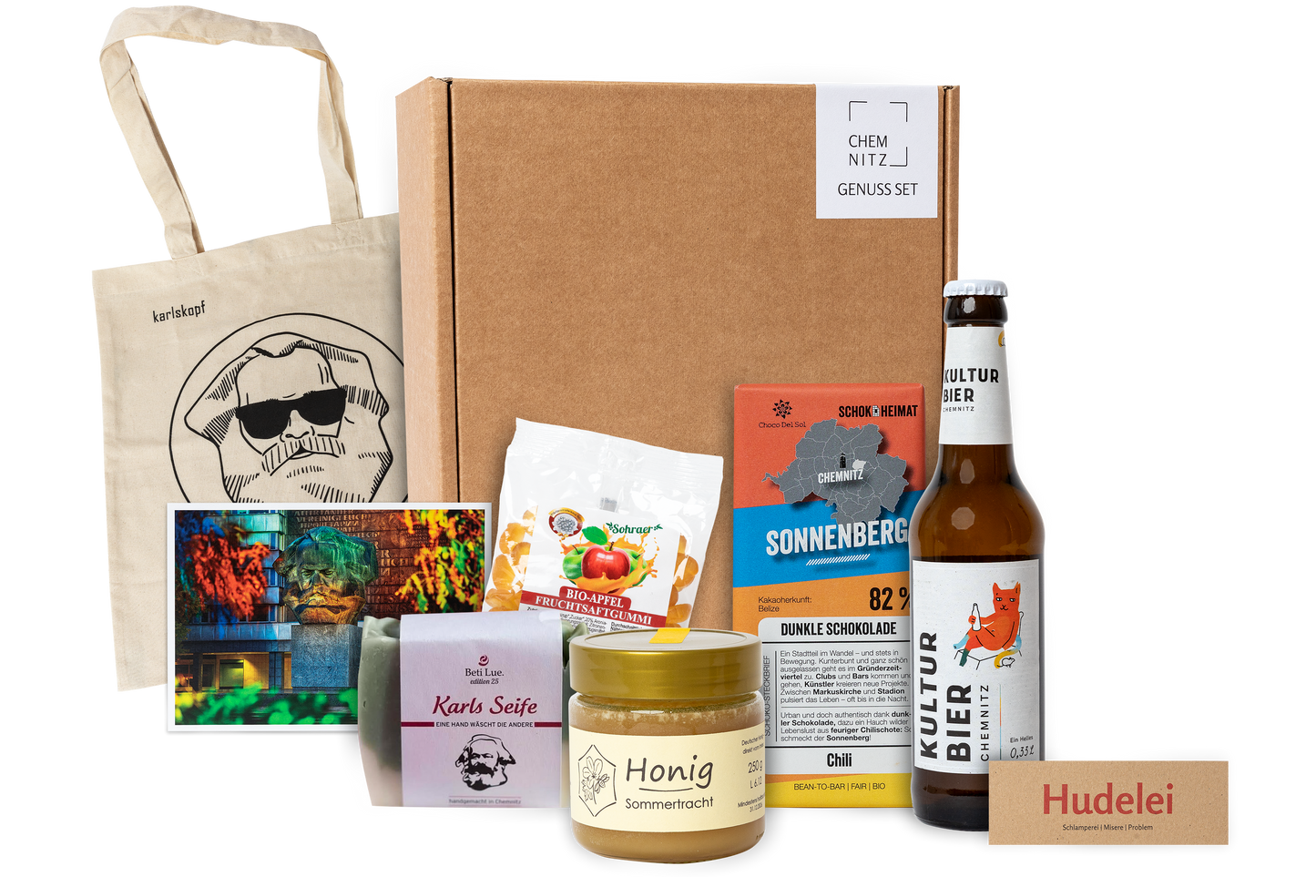 Genuss Set Chemnitz Basis mit Stofftasche, Bio Fruchtgummi, Karls Seife, Honig im Glas, Schokolade, Kultur Bier Chemnitz, alles in einem braunen Karton.