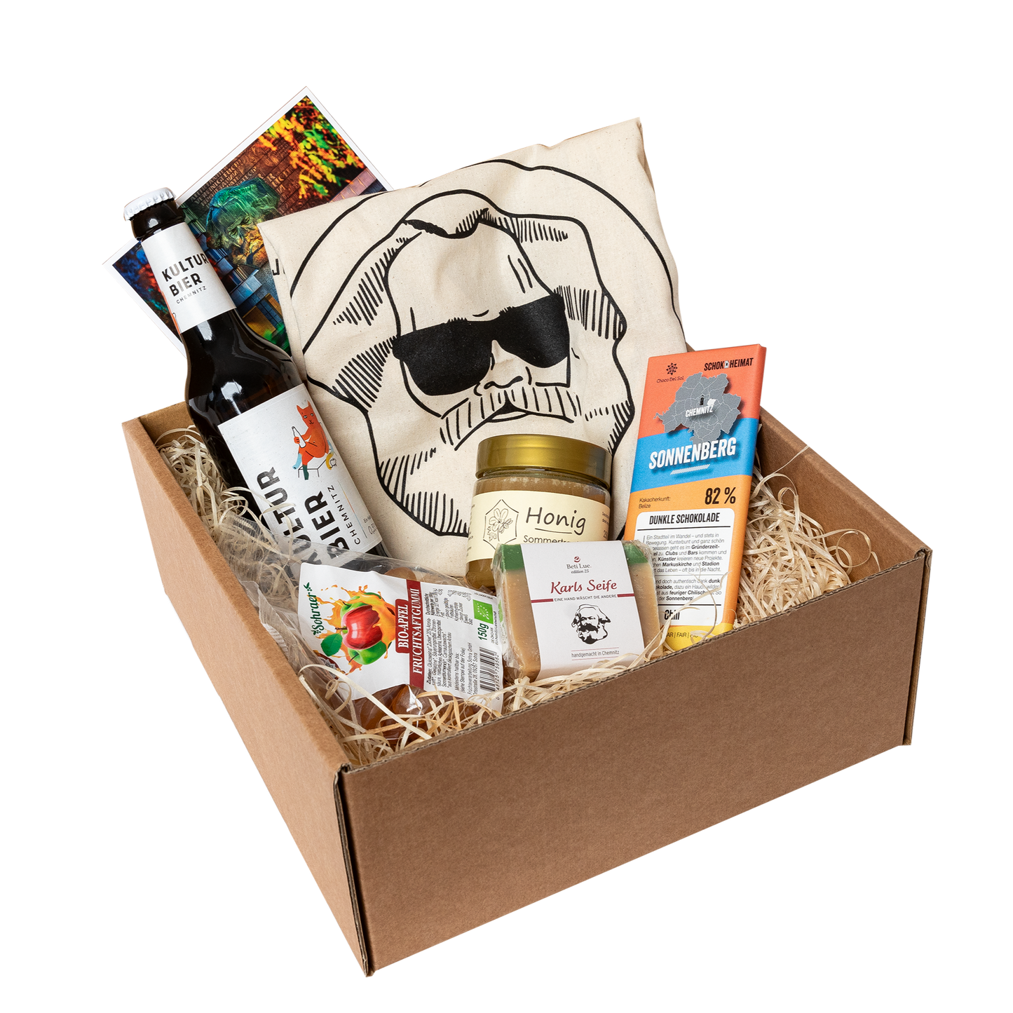 Genuss Set Chemnitz Basis mit Stofftasche, Bio Fruchtgummi, Karls Seife, Honig im Glas, Schokolade, Kultur Bier Chemnitz, alles in einem braunen Karton.