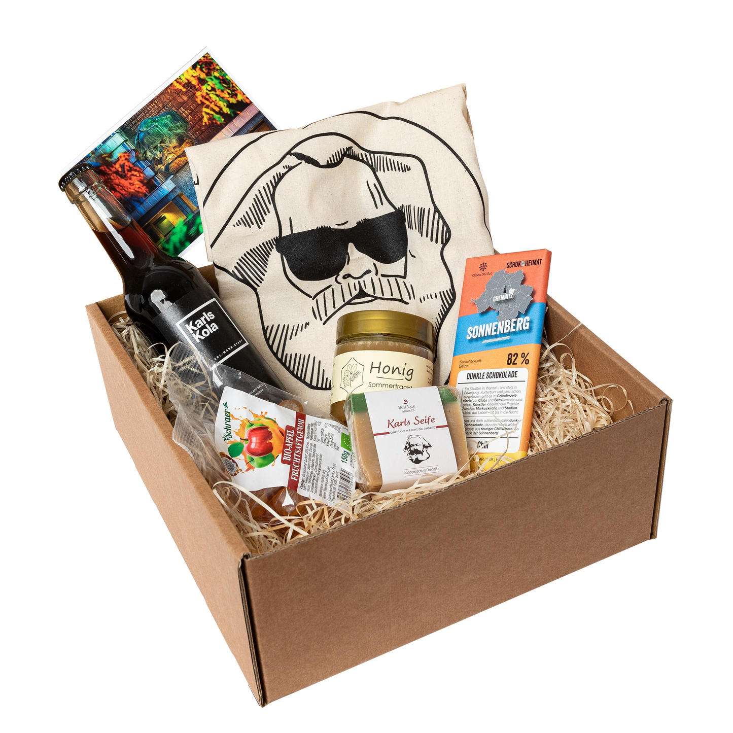 Genuss Set Chemnitz Basis mit Stofftasche, Bio Fruchtgummi, Karls Seife, Honig im Glas, Schokolade, Karls Kola, alles in einem braunen Karton.