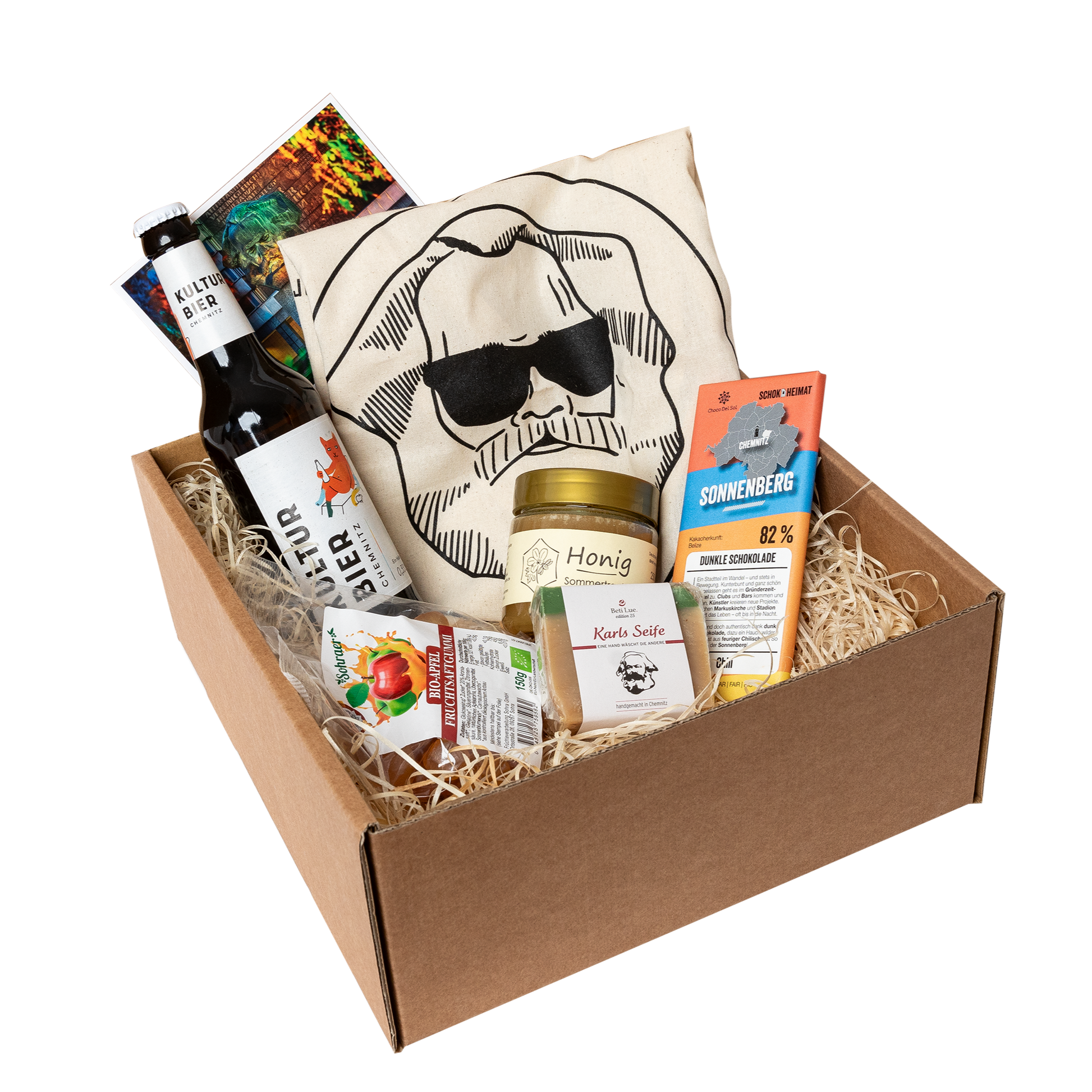 Genuss Set Chemnitz Basis mit Stofftasche, Bio Fruchtgummi, Karls Seife, Honig im Glas, Schokolade, Kultur Bier Chemnitz, alles in einem braunen Karton.